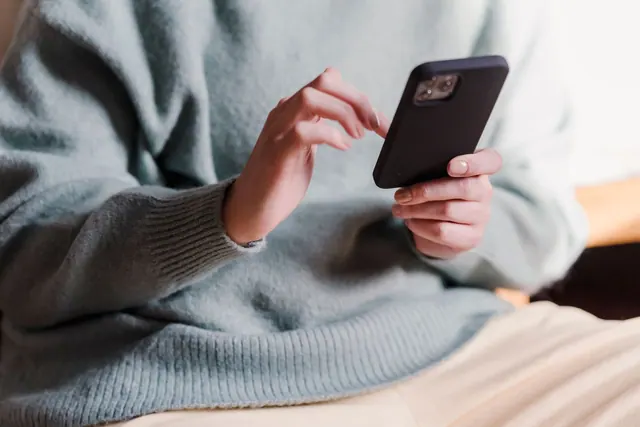Crop faceless female in casual clothes using smartphone and touching screen while chilling at home. A practical digital communities checklist