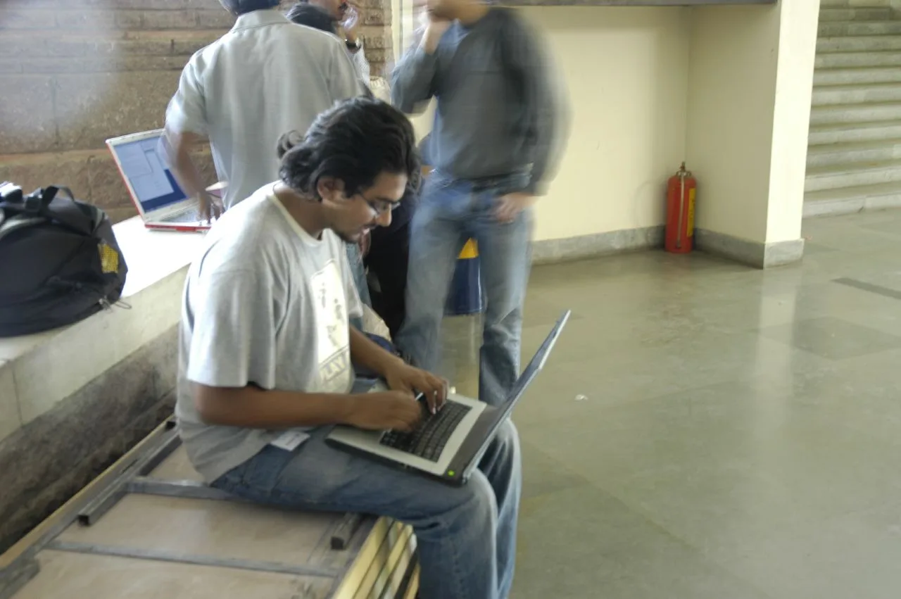 People using laptop computers at a 2006 free and open source software event in Bangalore